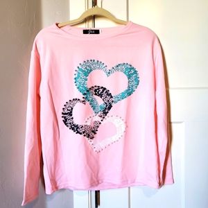 CBR Pink long sleeve shirt with teal, black and white hearts.